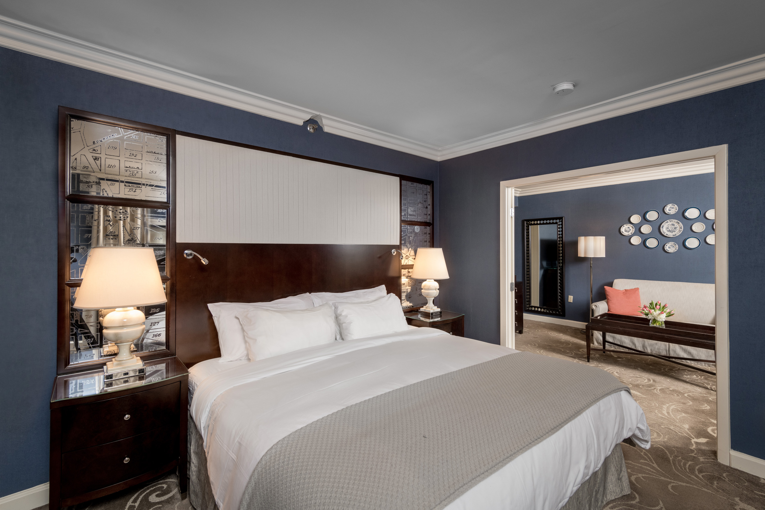 One-bedroom suite at Hamilton Hotel DC with lounge space, workspace, and sliding glass doors