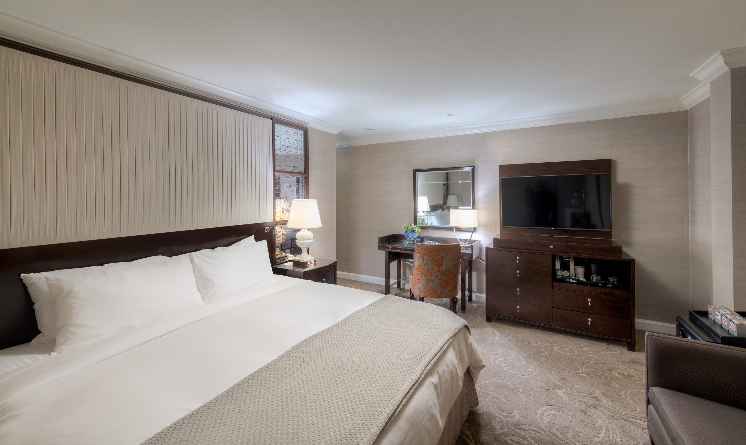 King bedroom with desk and television.