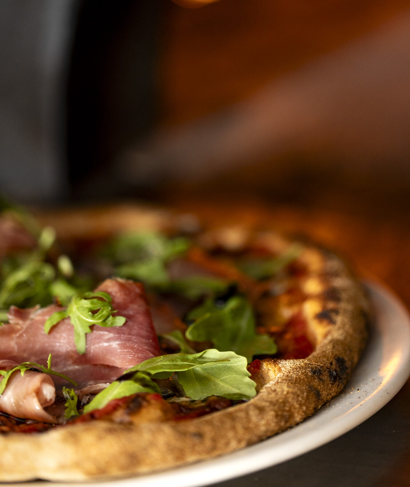 pizza with prosciutto and greens