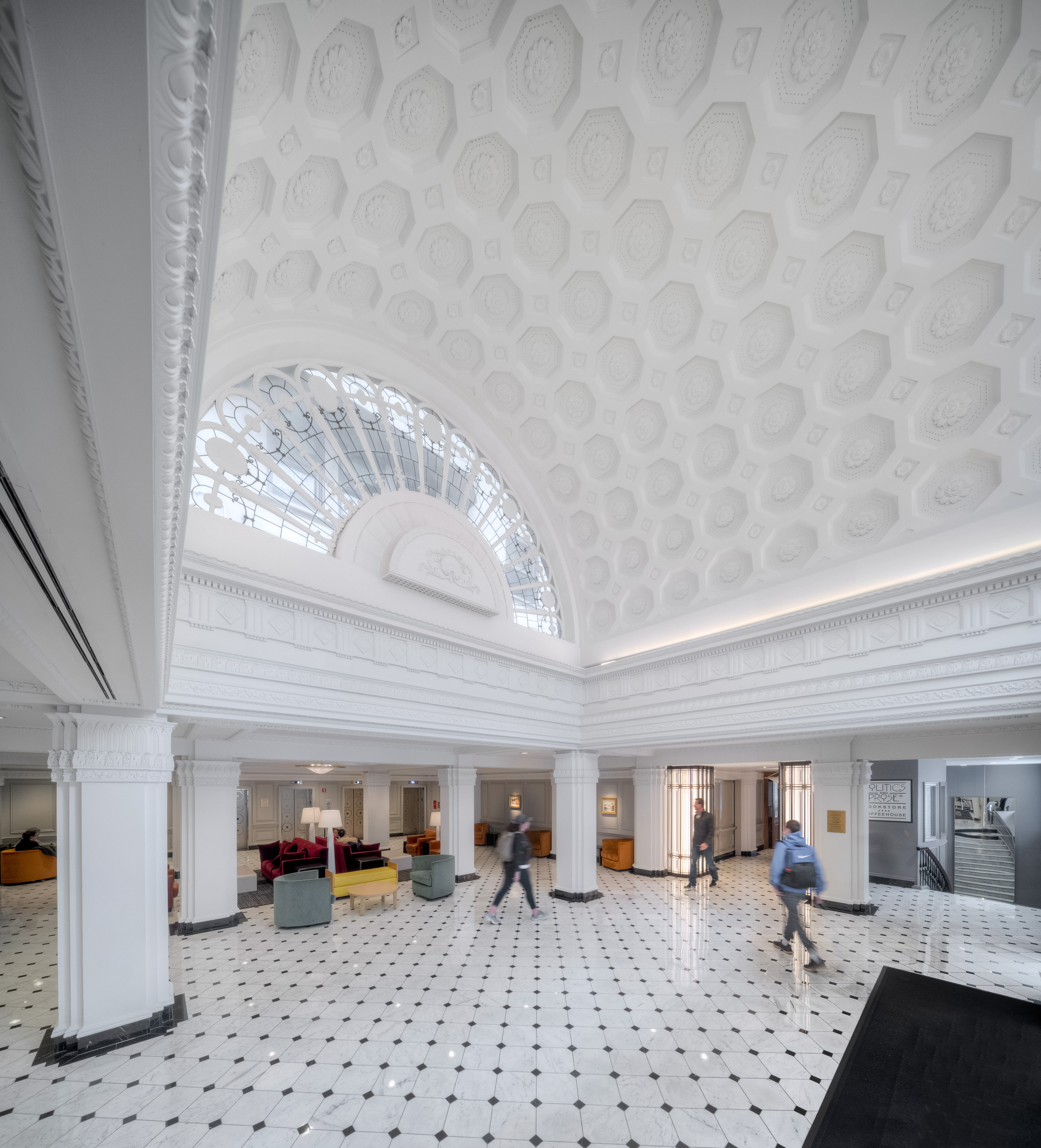 Ornate white lobby with marble floors.