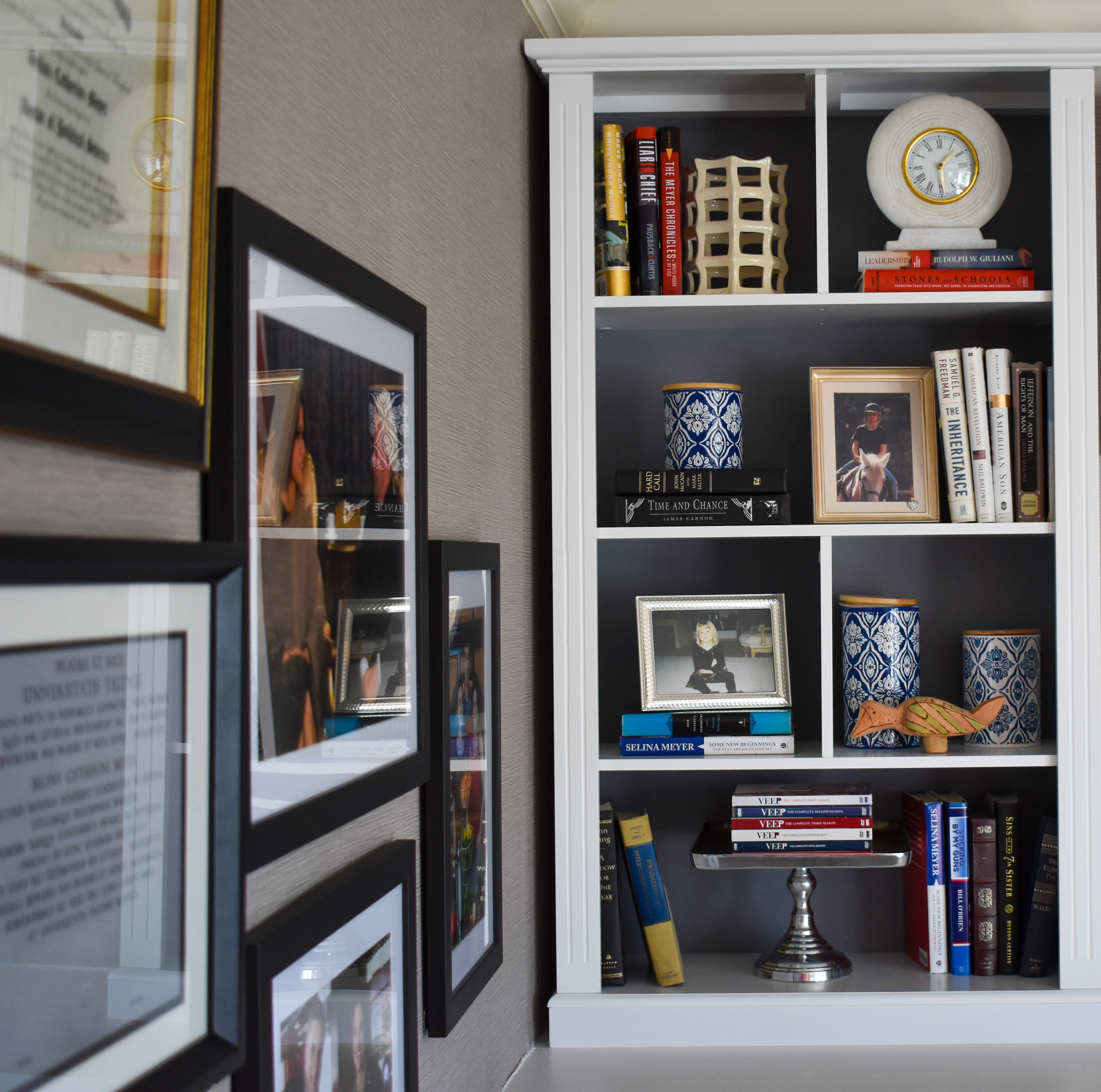 Bookshelf styled with photos and decorative accents.