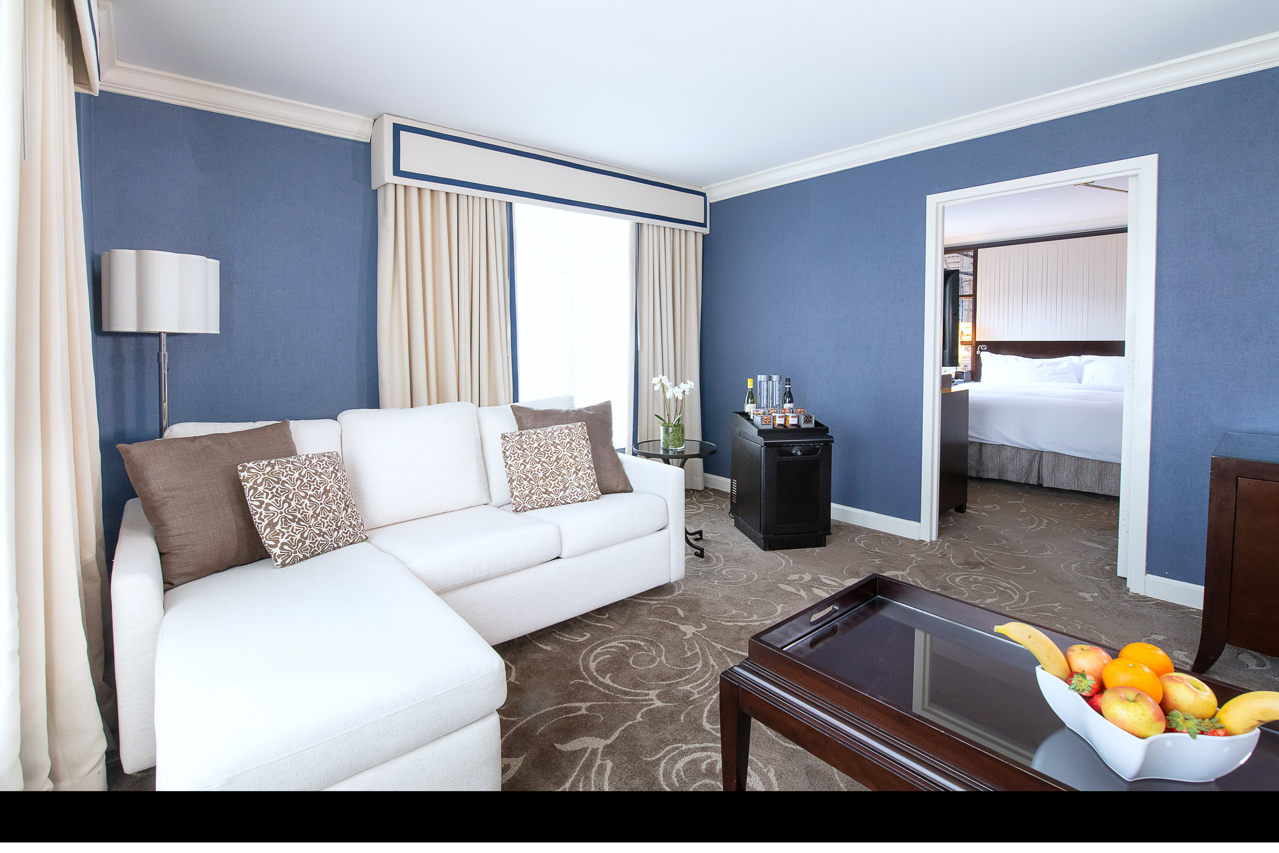 Spacious living room suite at Hamilton Hotel DC with sectional sofa and separate king bedroom