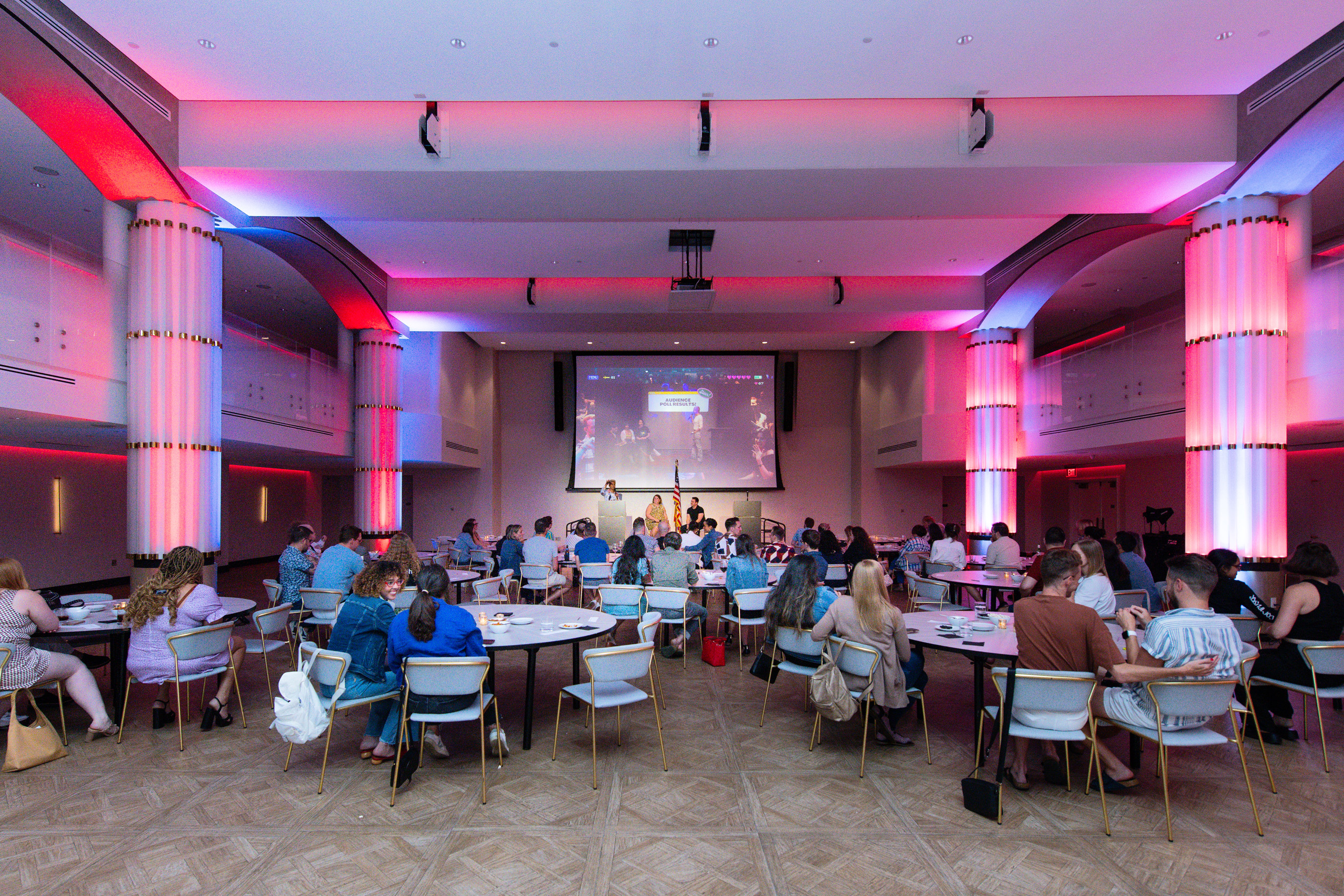 Conference presentation in illuminated ballroom