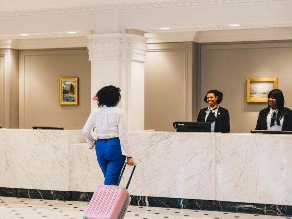 Guest checking in at marble reception desk