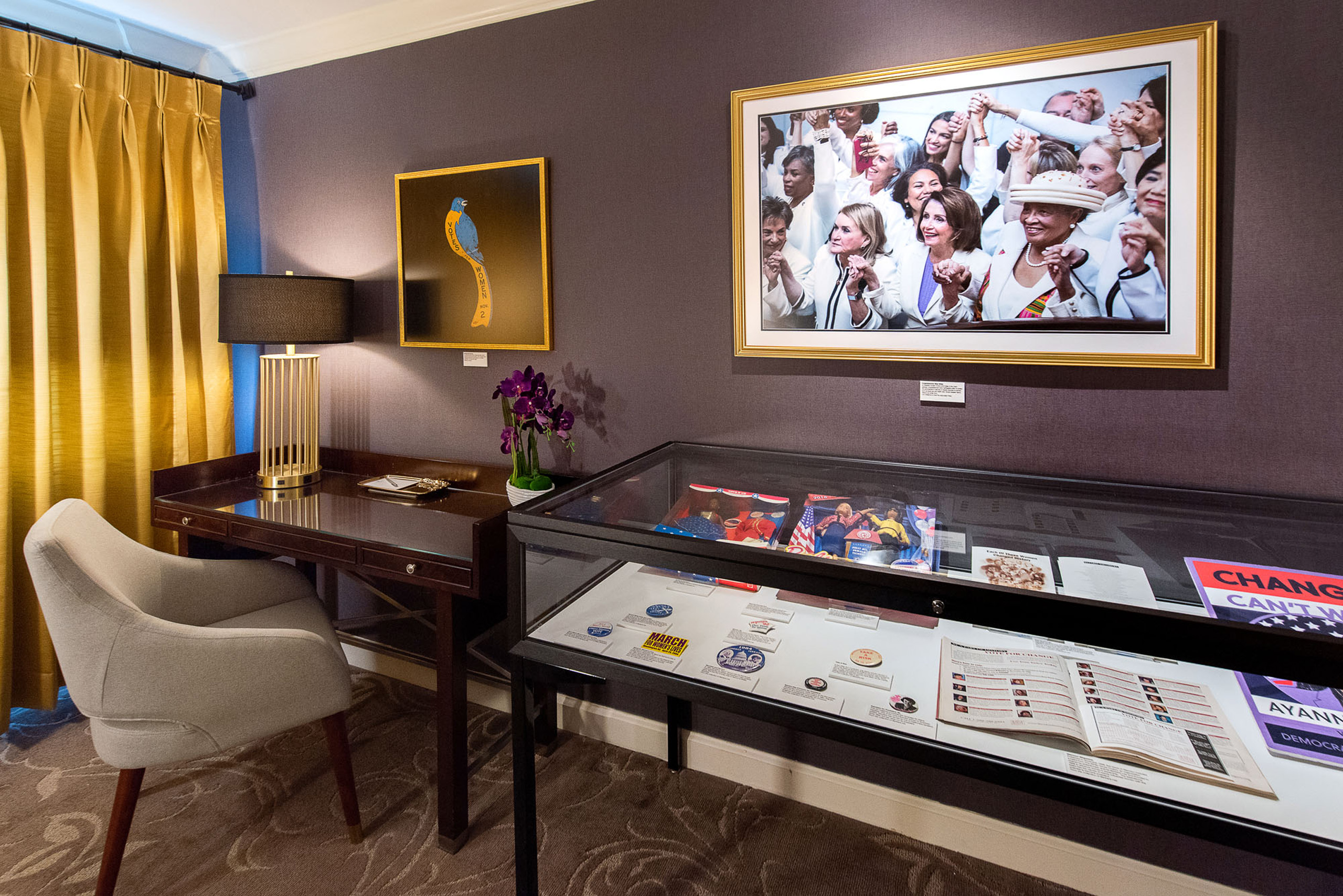 Workspace with display case and framed art.