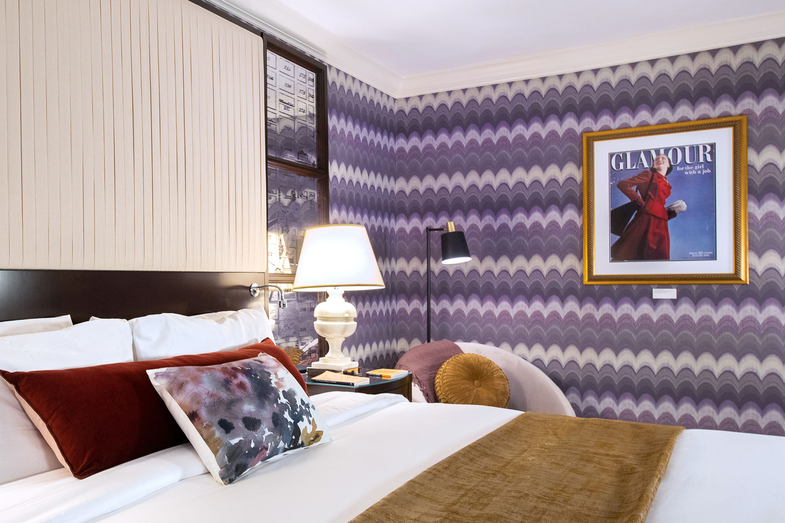 Glam bedroom with bold patterned wallpaper.