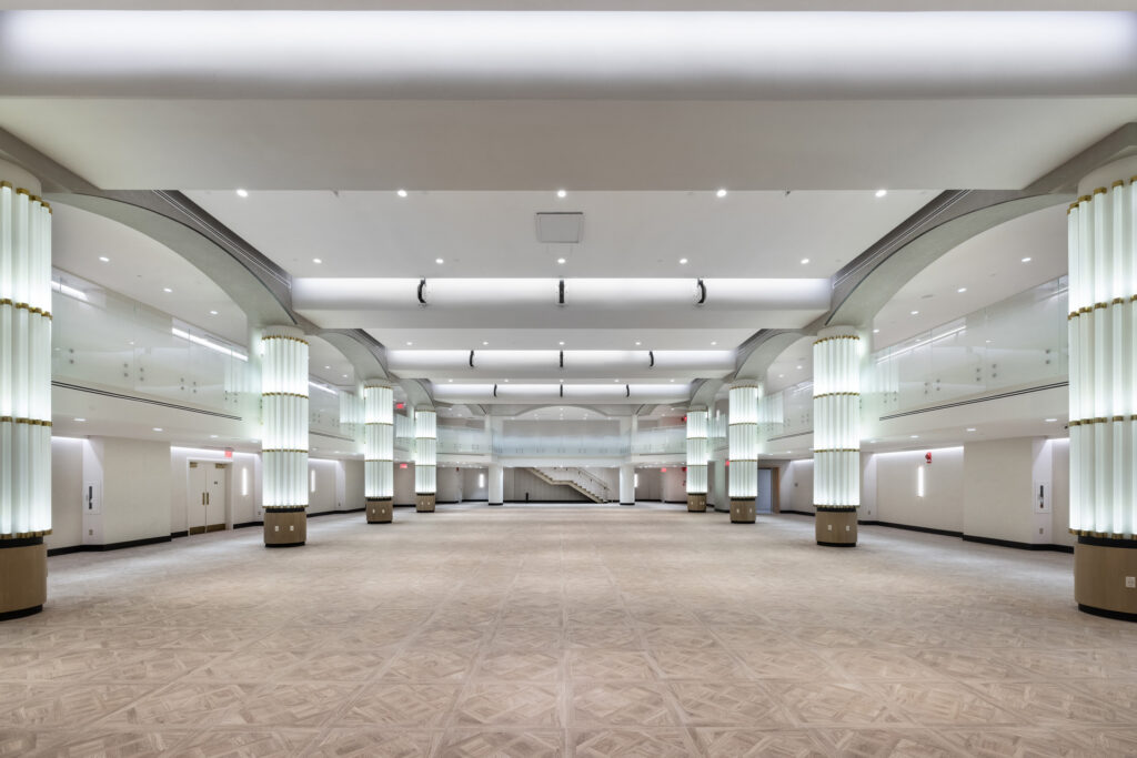 Expansive ballroom with illuminated columns.