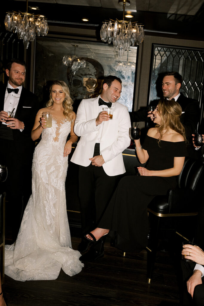 Wedding party toasting in stylish lounge.