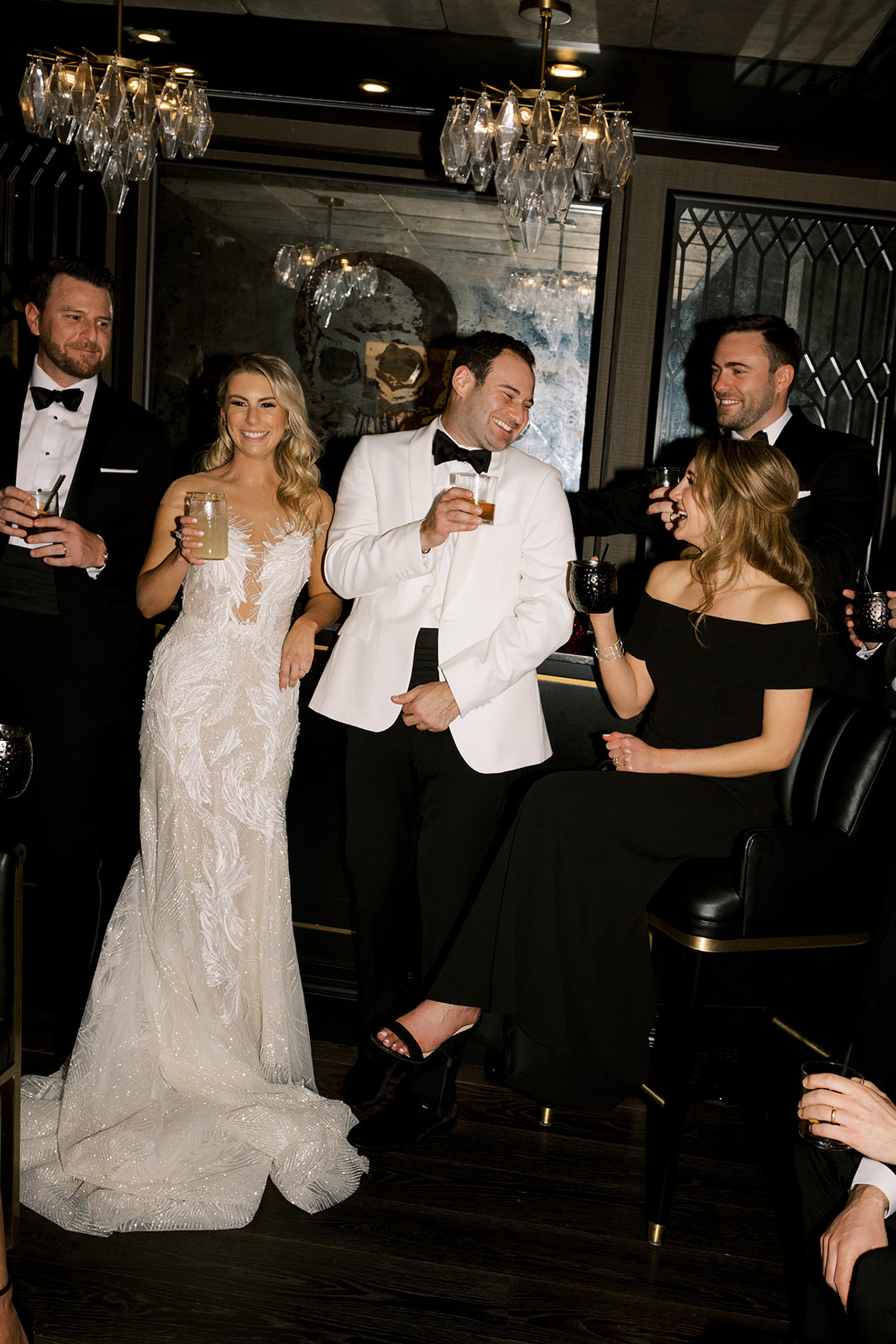 Wedding party toasting in stylish lounge.