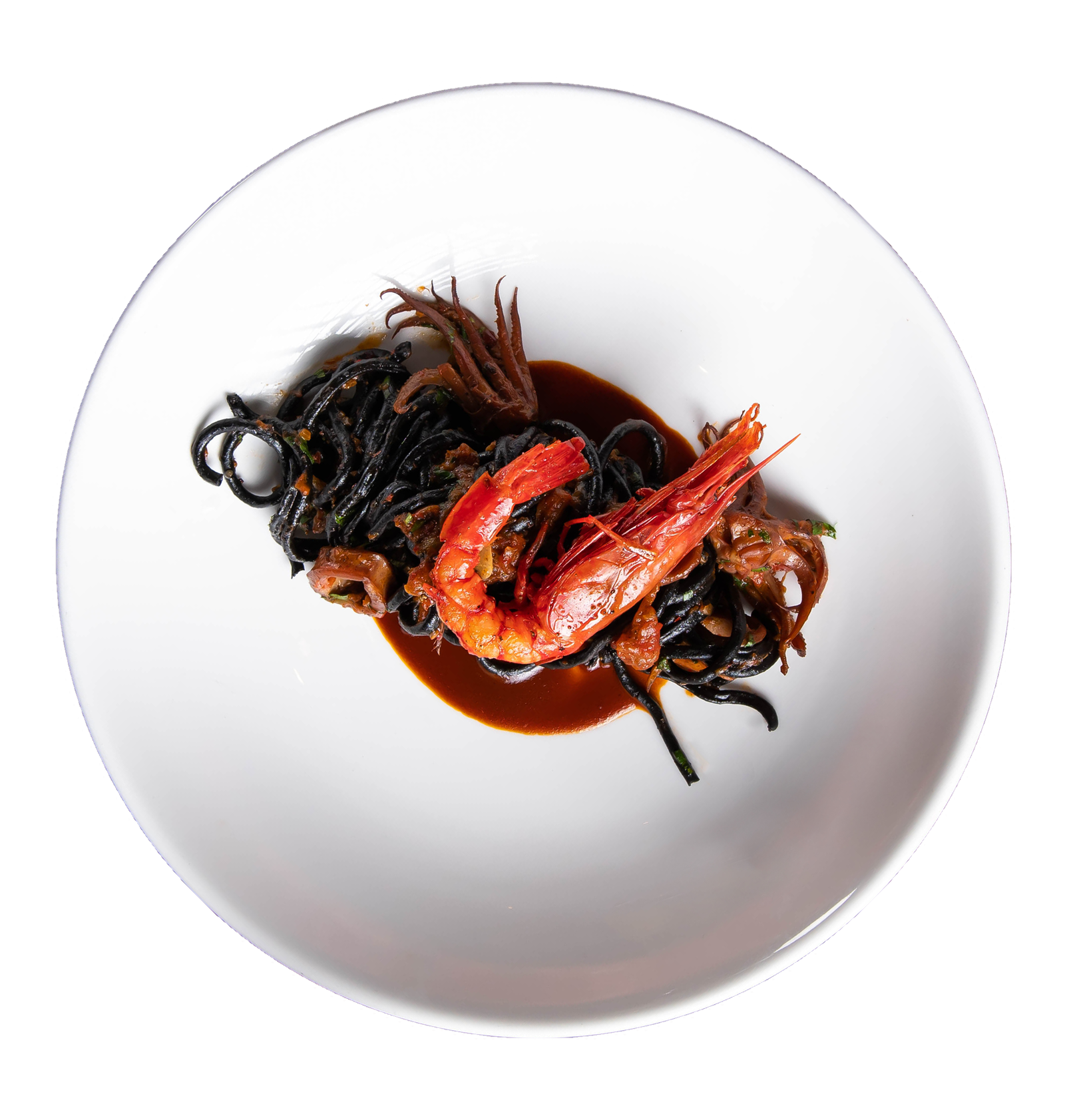 Squid ink pasta with prawns and seafood in rich sauce on white plate