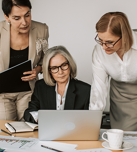 three women working at a computer