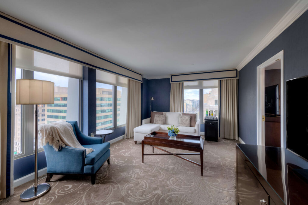 Spacious suite living room at Hamilton Hotel DC with skyline views and separate seating area