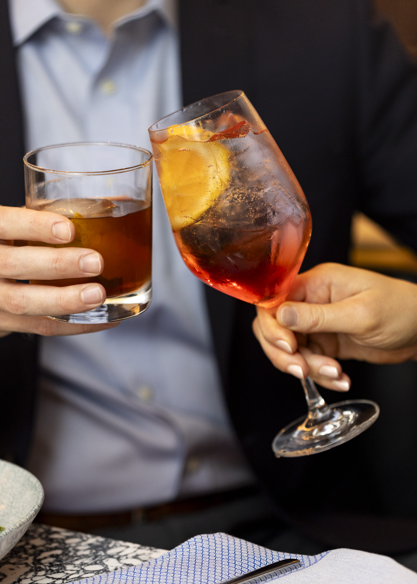 man and woman toasting with cocktail and sangria