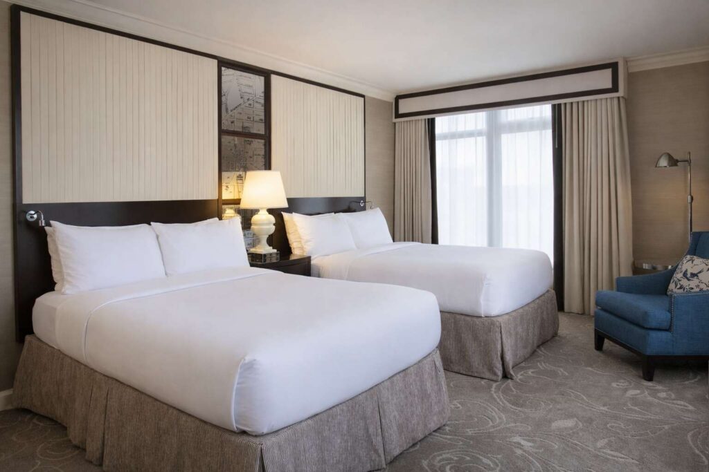 Two queen beds in elegant hotel room.