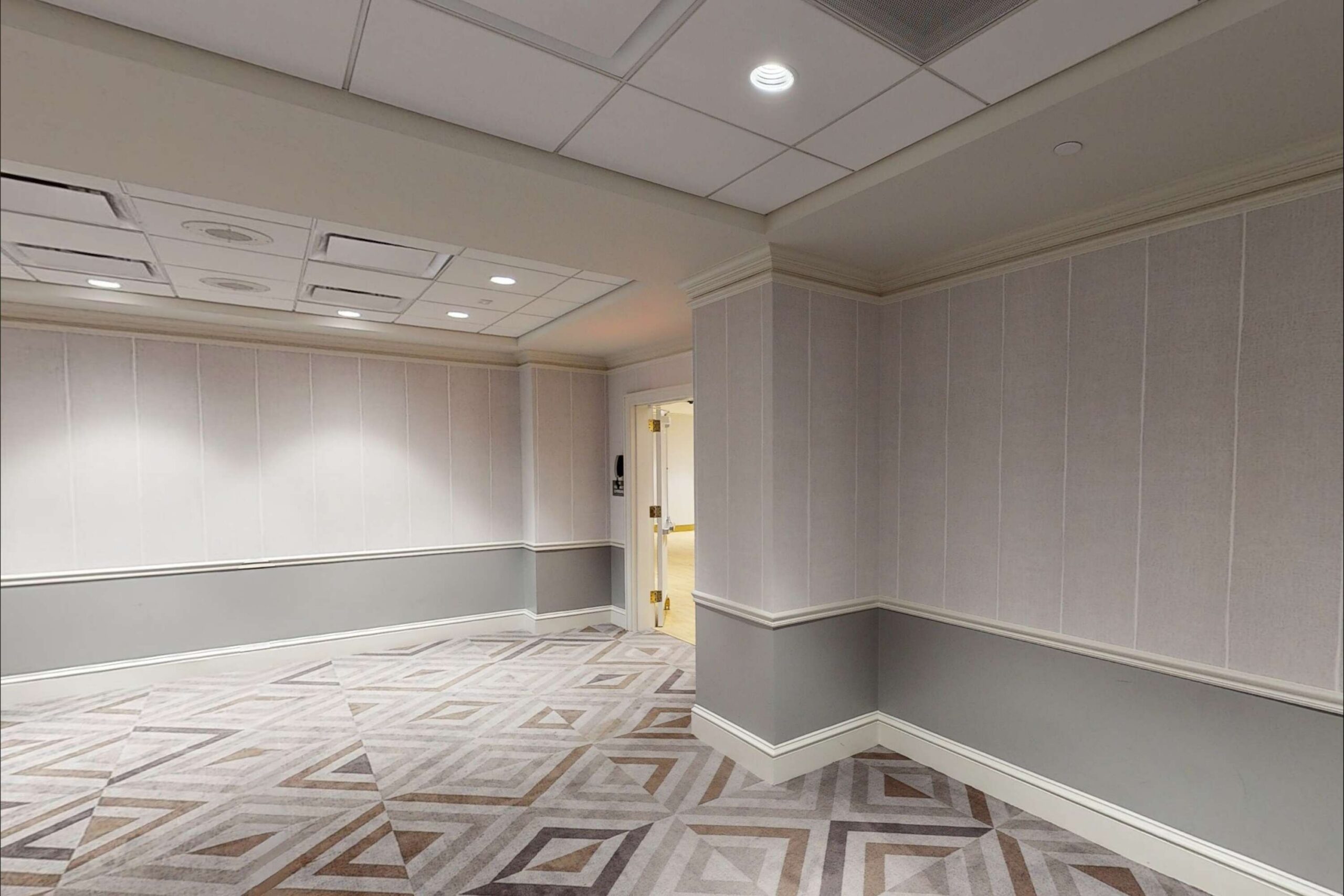 grey wall and diamond carpeted meeting room