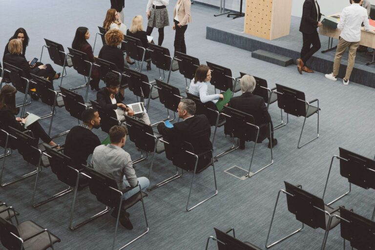 chairs arranged in auditorium seating with meeting attendees