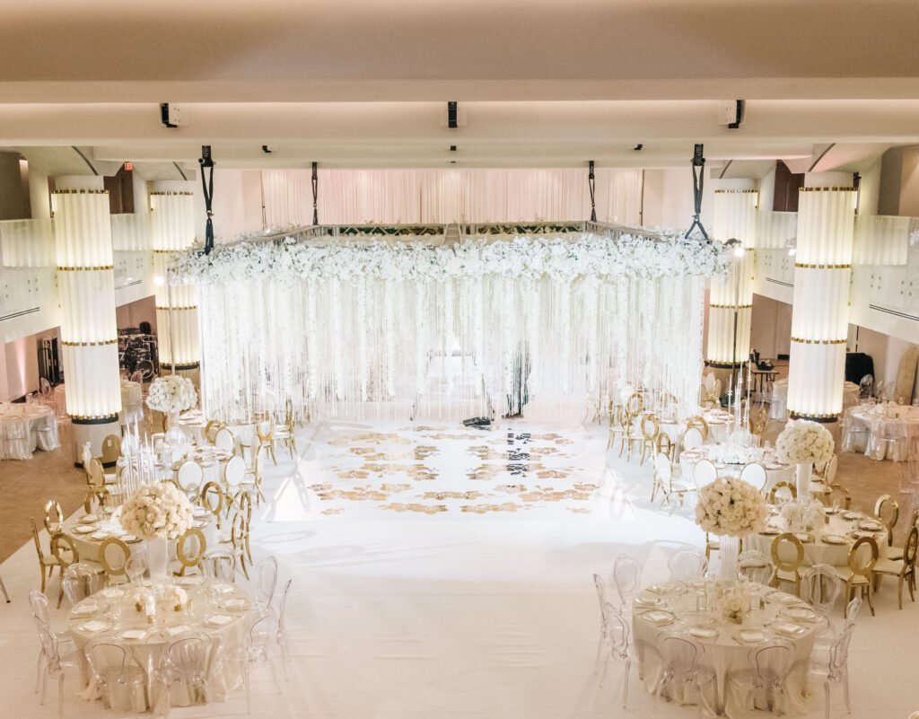 ballroom set up for wedding with several 8-top round tables