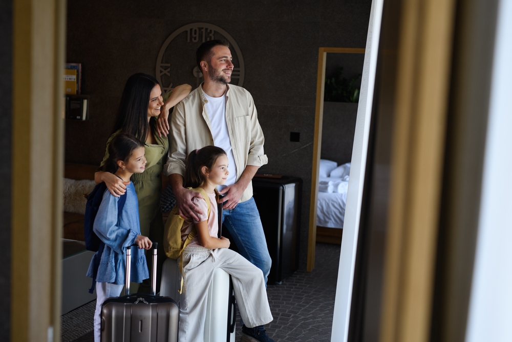 young family stood in a hotel suite